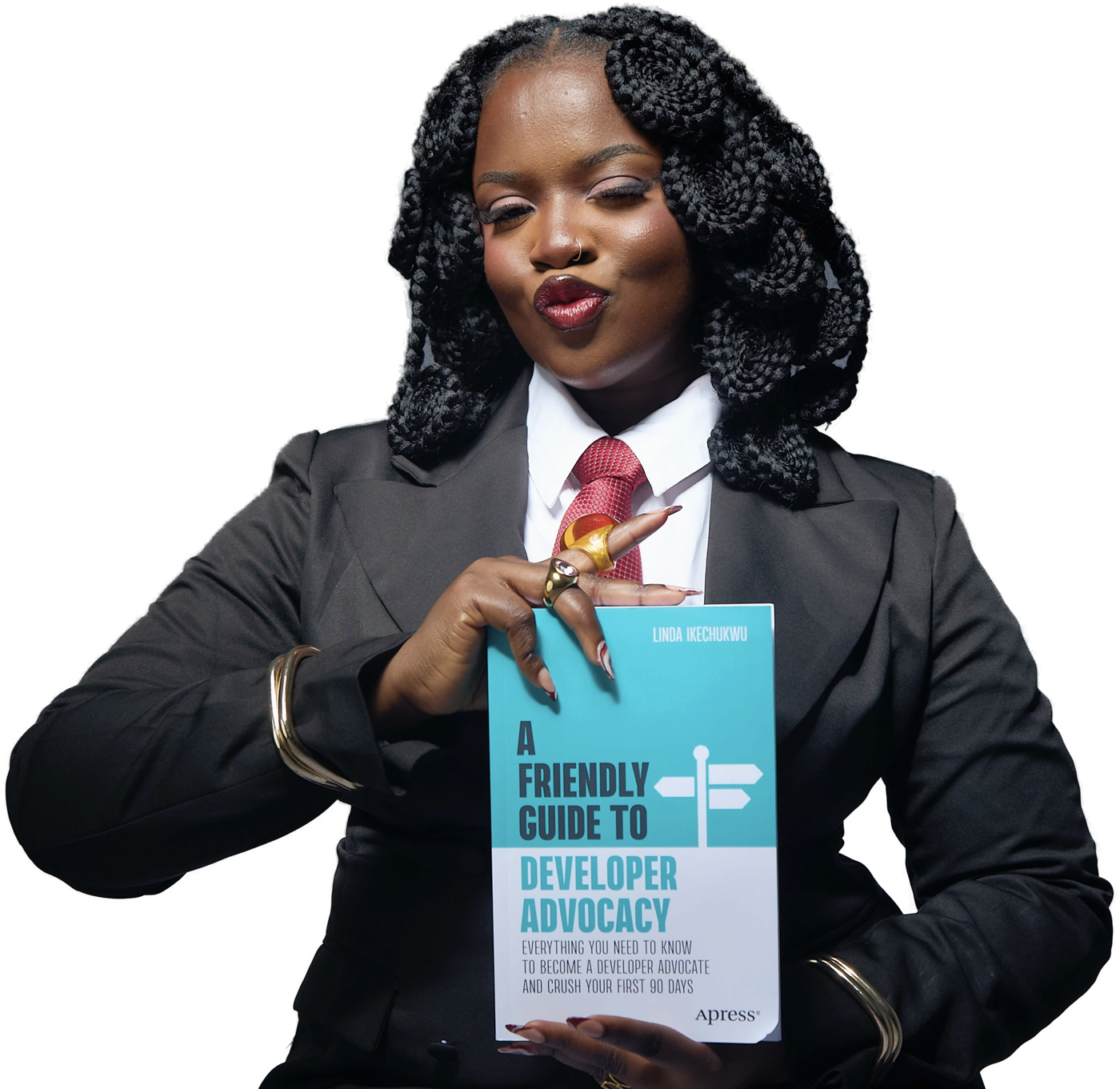 Linda Ikechukwu holding her book, A Friendly Guide to Developer Advocacy